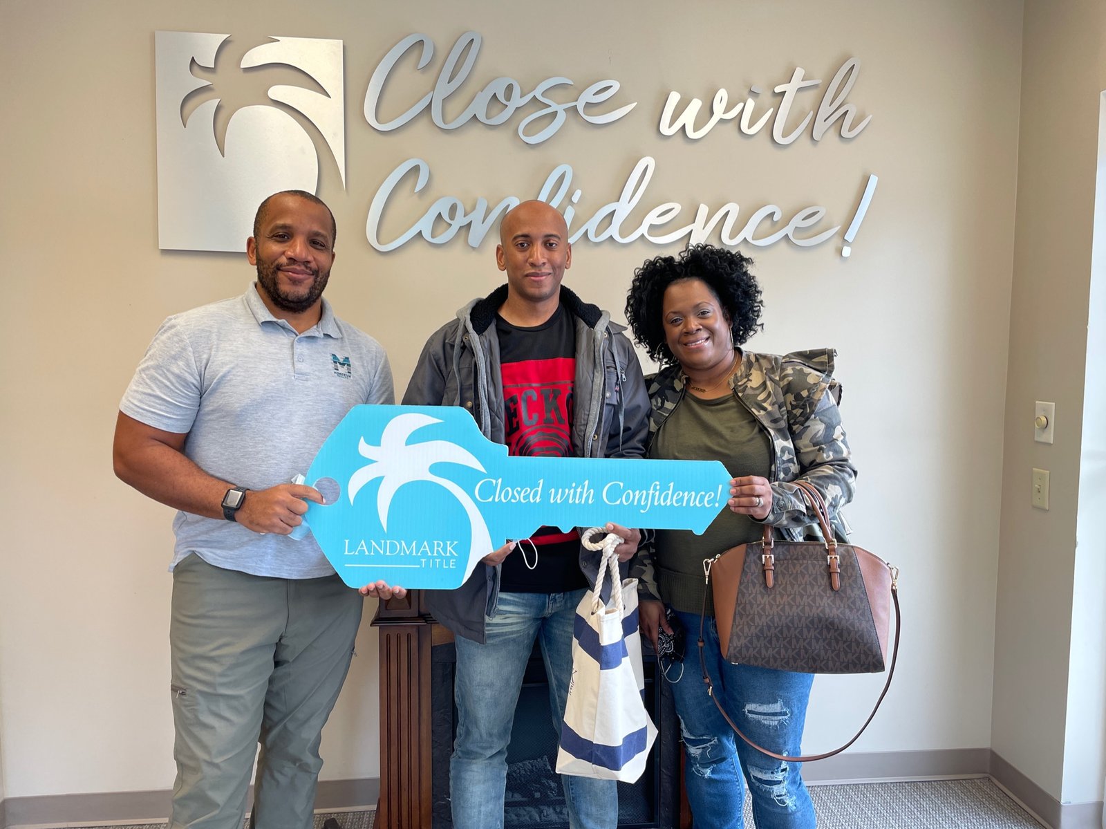 A Jacksonville family holding the ceremonial key with Chris Moore at their closing